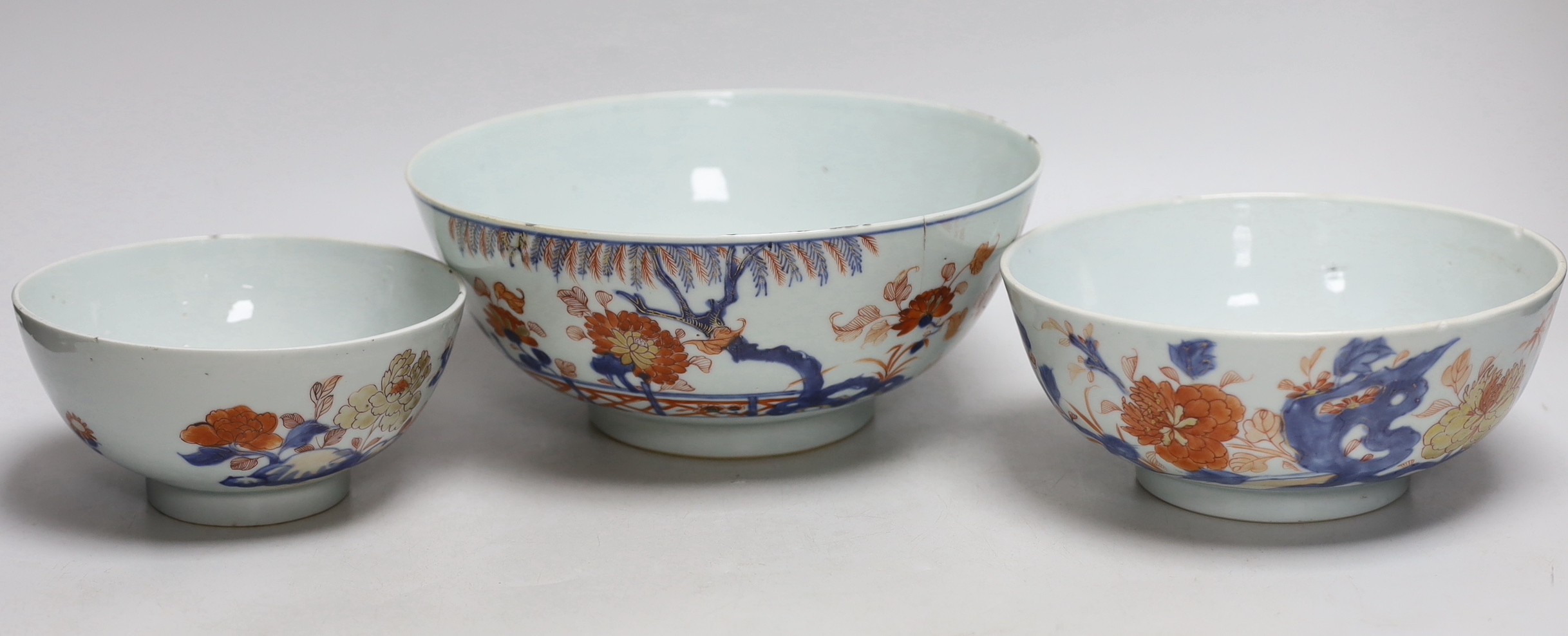 A graduated set of three Chinese Imari bowls, Qianlong period, hand painted with flowers, the largest 23cm in diameter